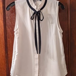 Sleeveless white blouse with tie